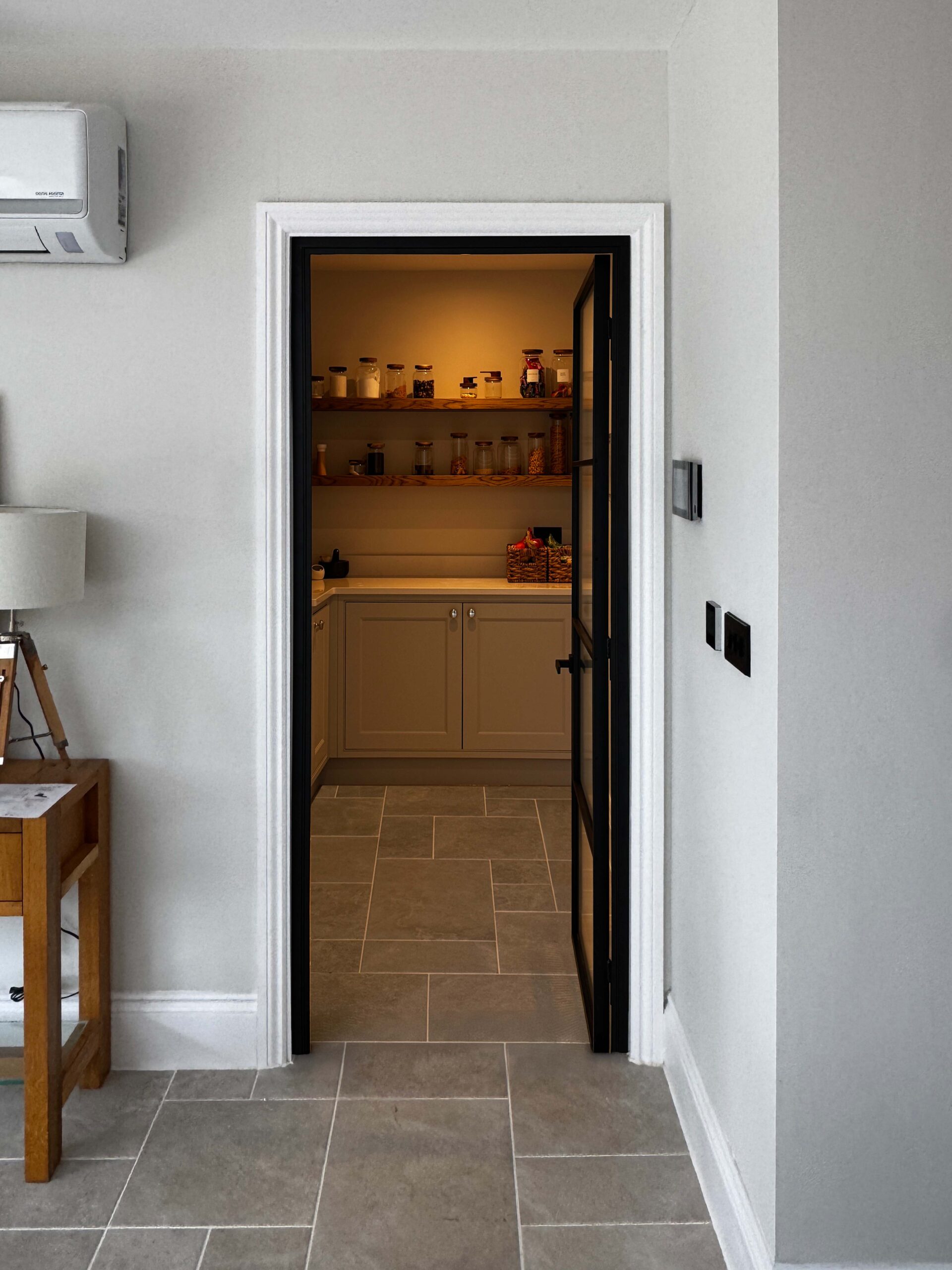 Modern kitchen pantry with steel glass door