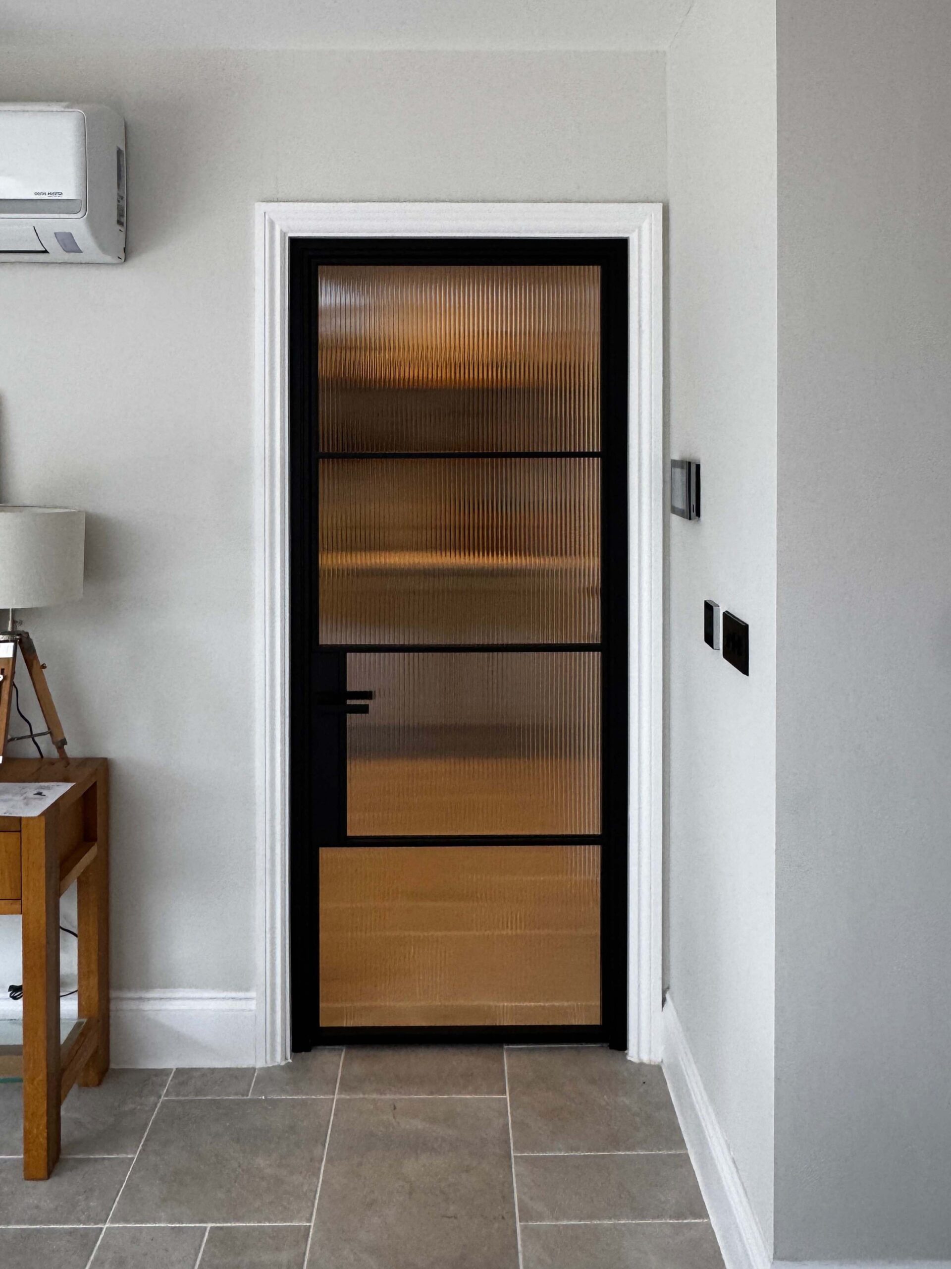 Modern interior door with glass panels and black frame design