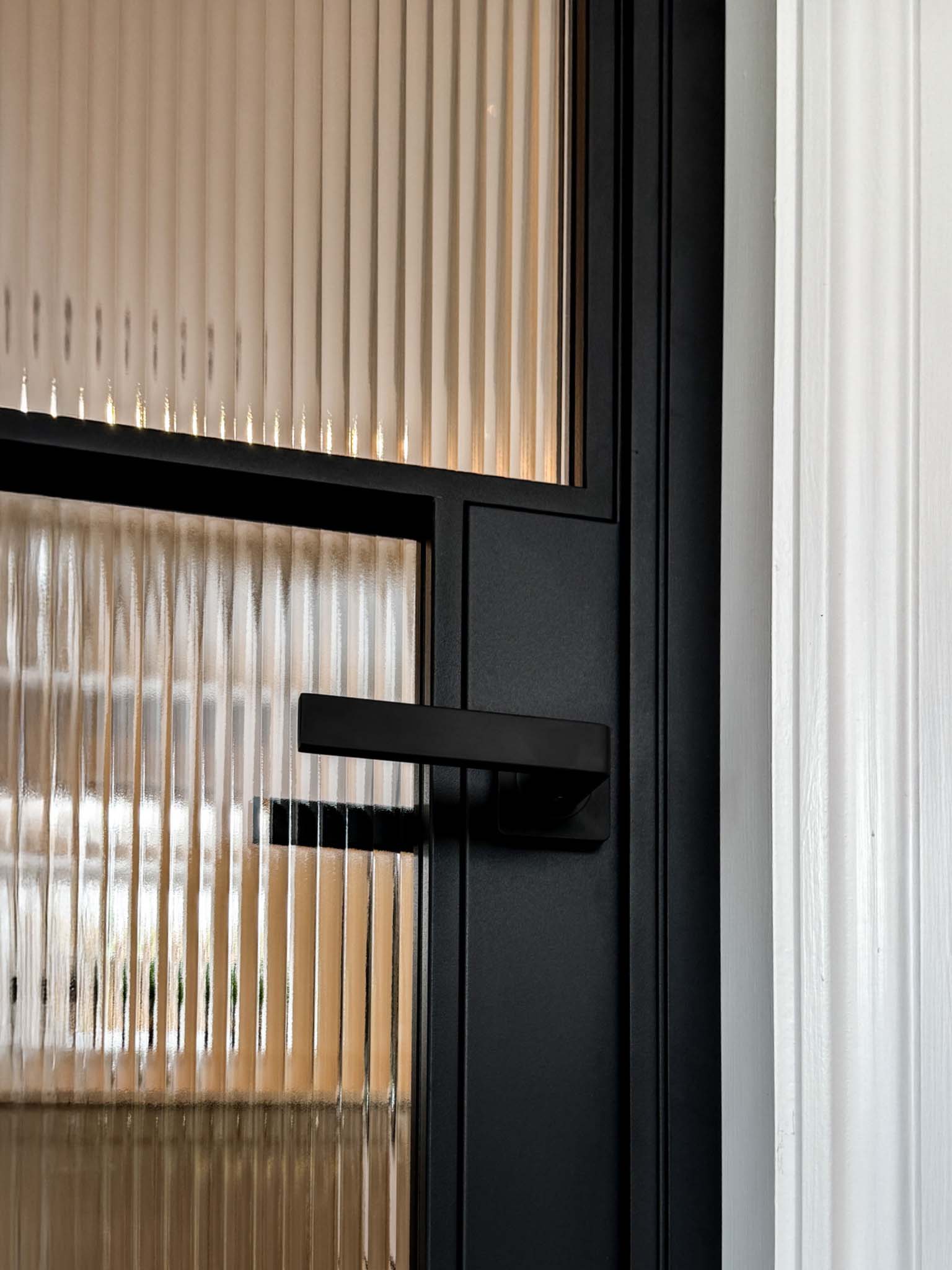 Modern black metal frame door with textured glass panels