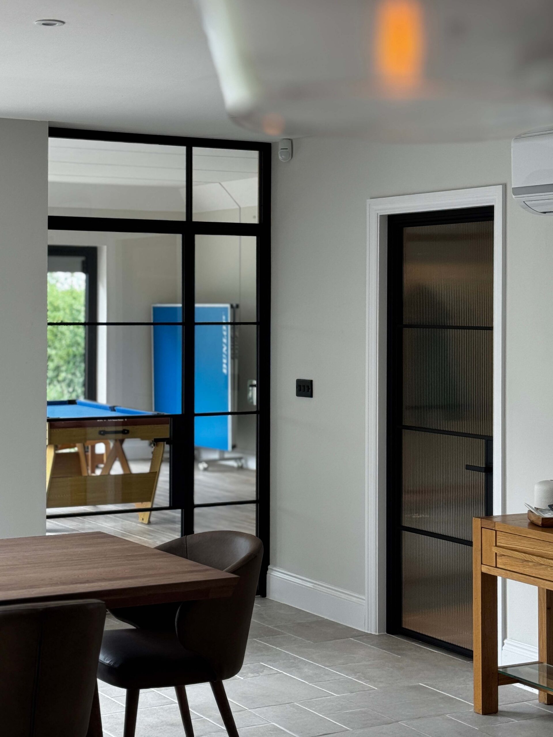 Modern interior with glass doors and dining area visible